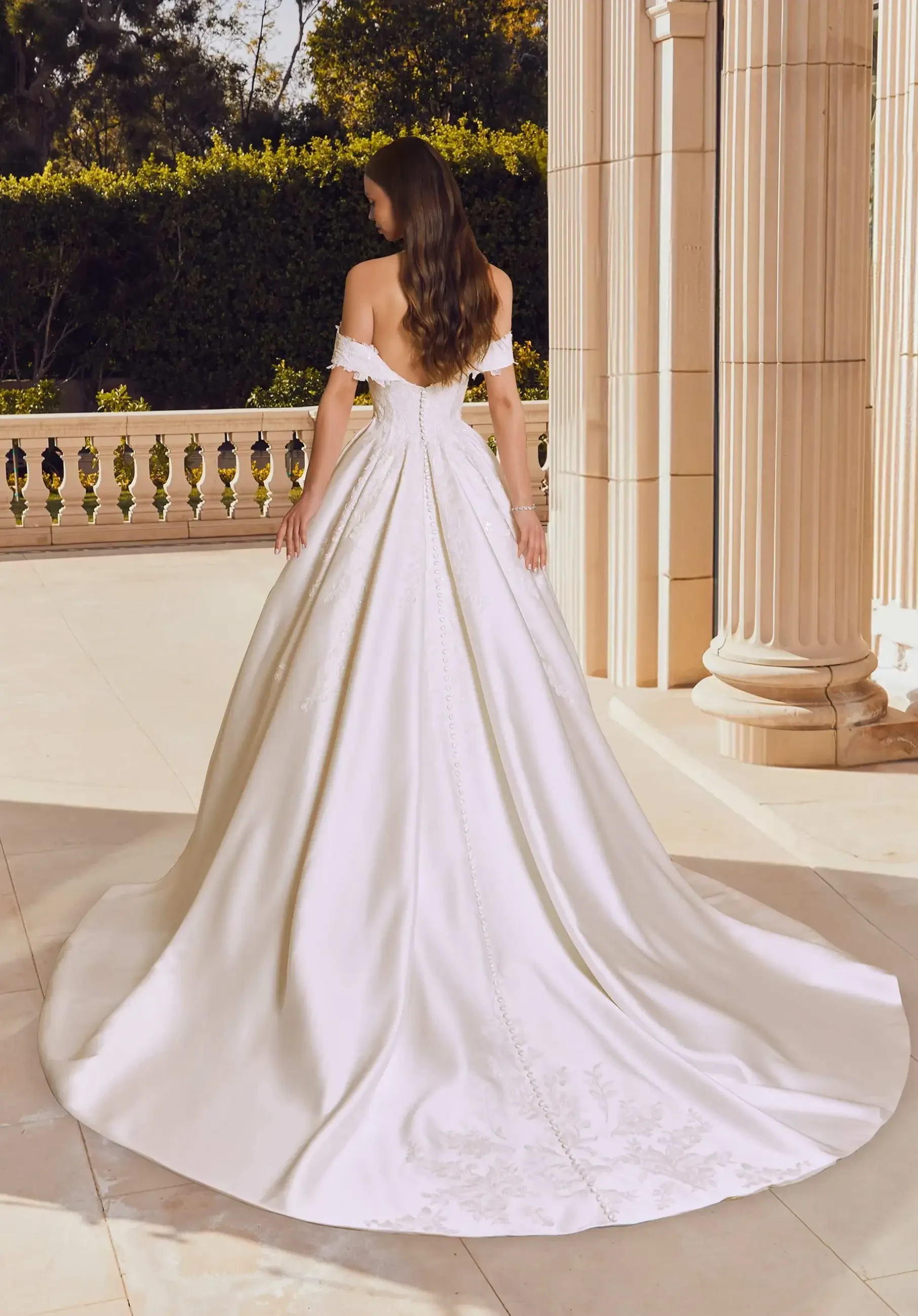 model is wearing a strapless ball gown wedding dress by morilee
