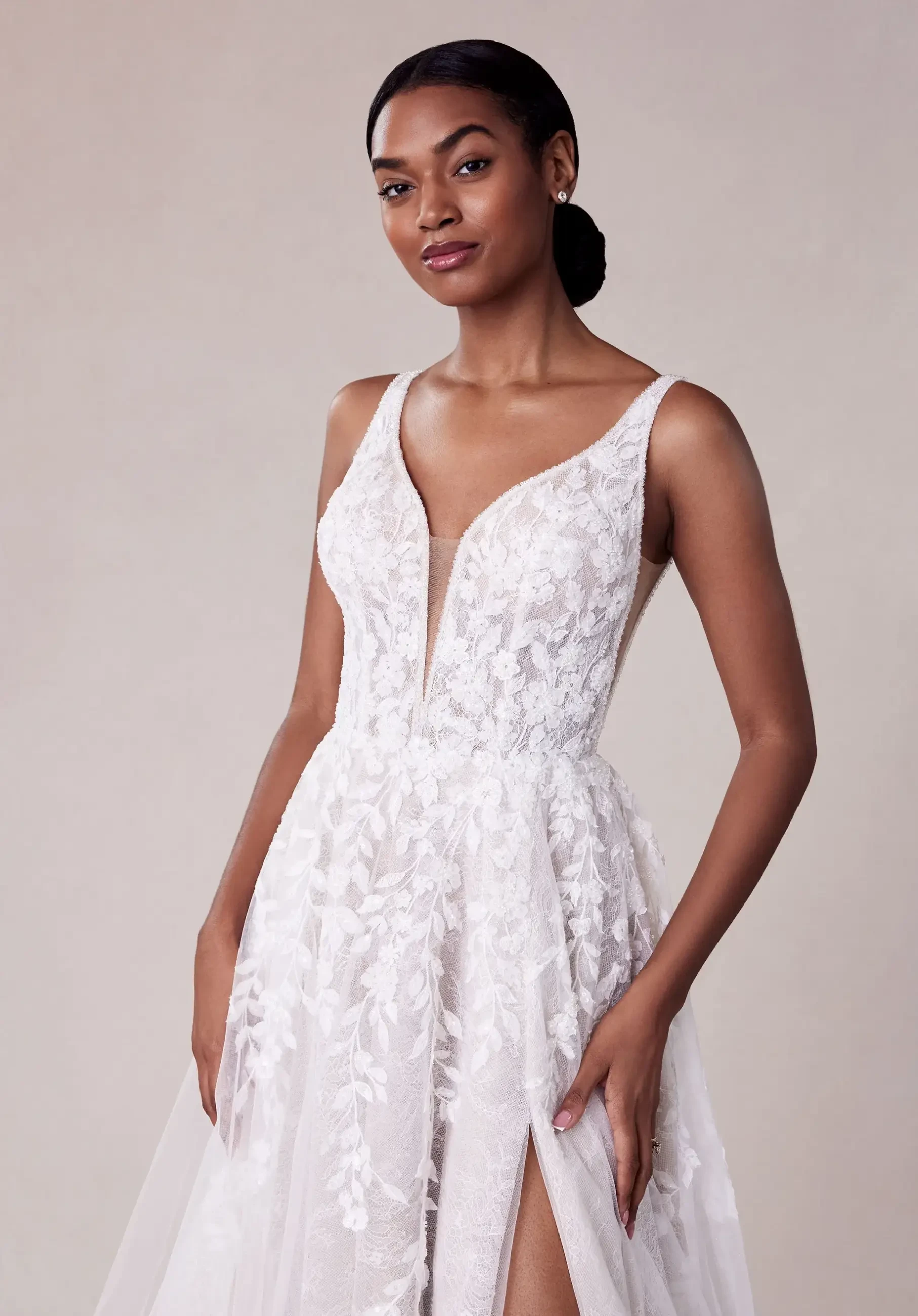 model is wearing a sleeveless a-line wedding dress with an open back by morilee