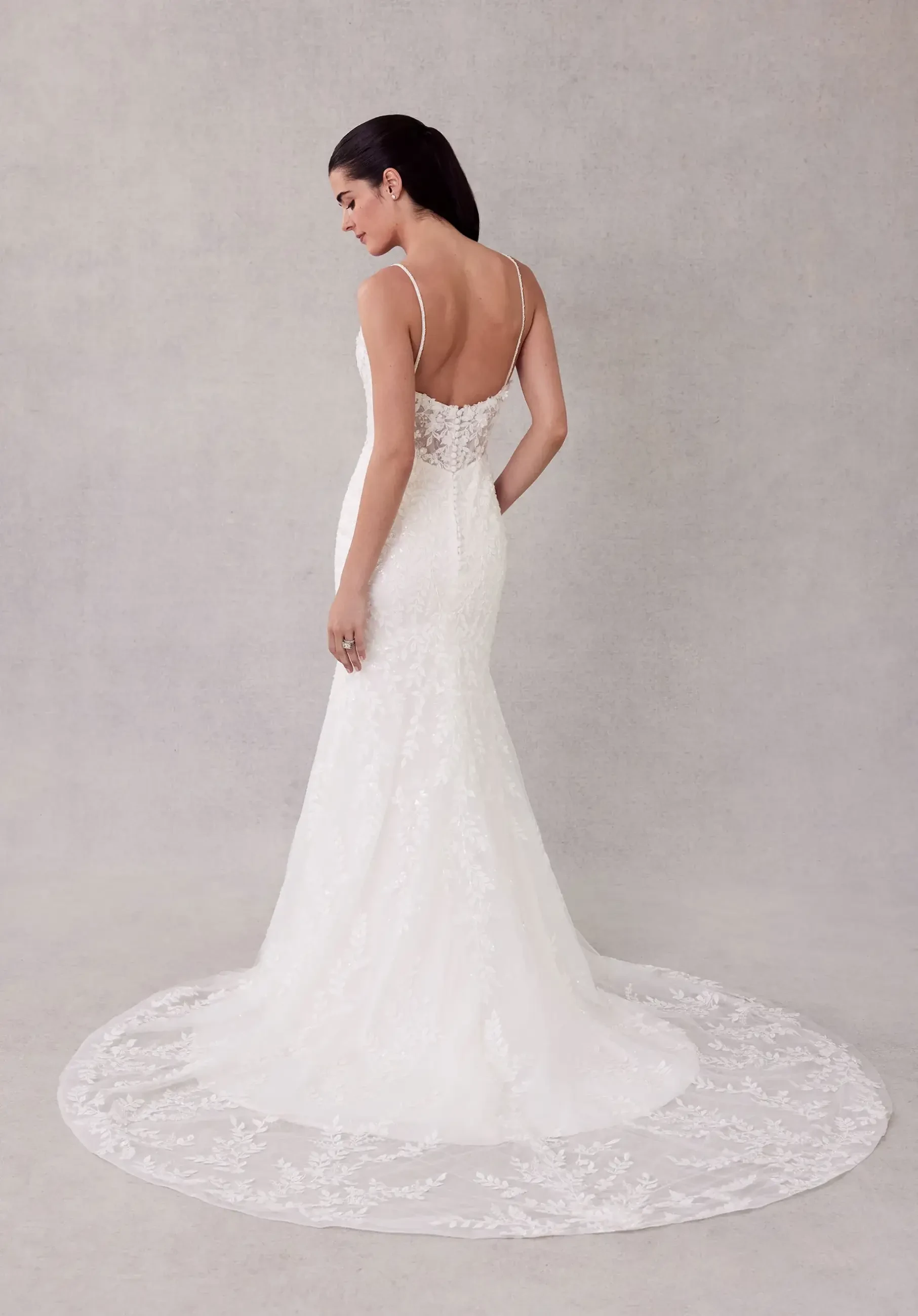 Model is wearing a fit-and-flare gown with three-dimensional beaded botanical lace, glitter net fabric for sparkle, and a detachable tulle overskirt.