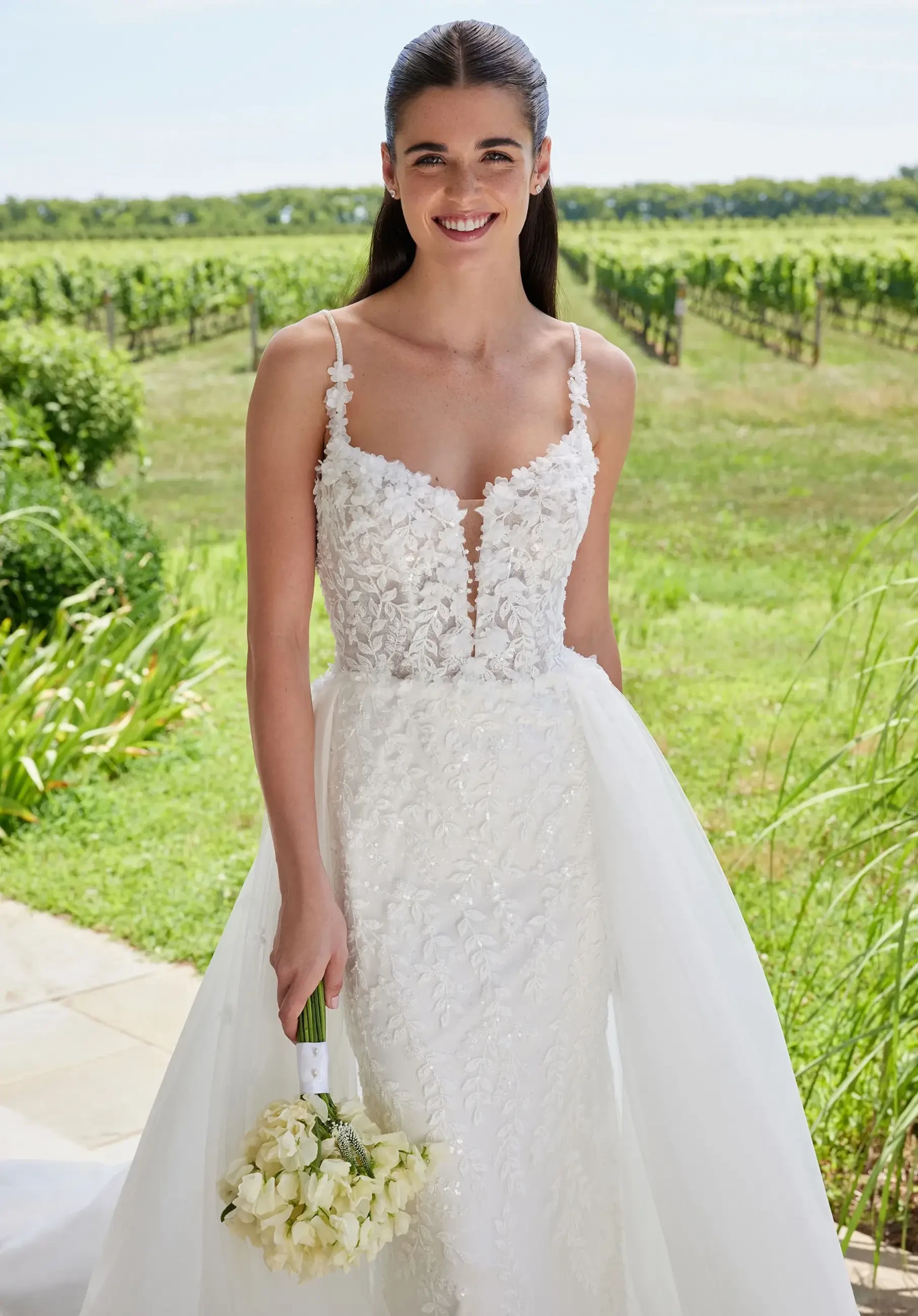 model is wearing a sleeveless a-line bridal gown