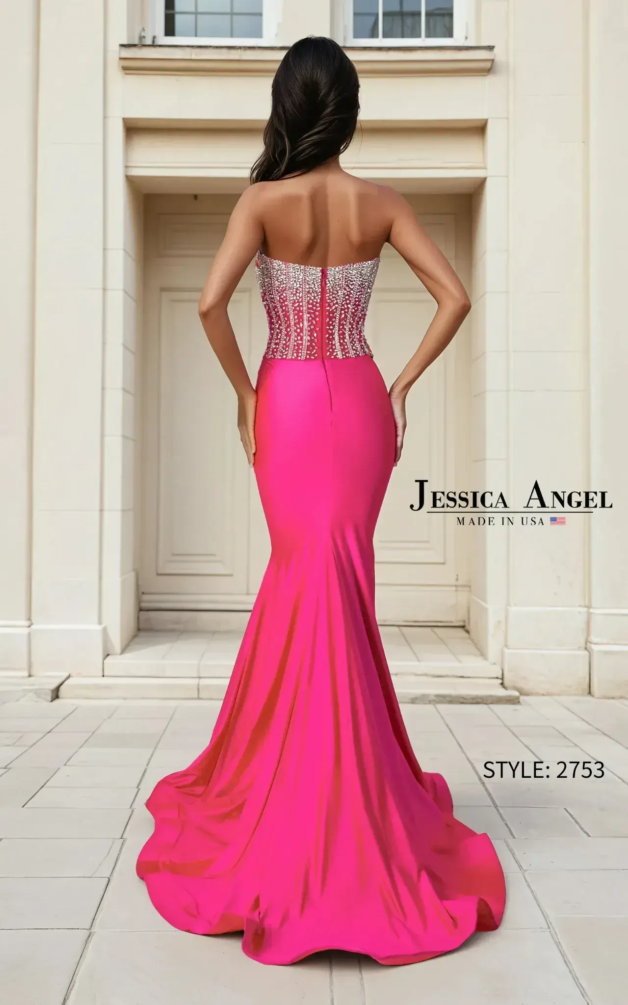 A woman stands confidently in a bright pink strapless gown with a sparkling silver bodice. She poses in front of elegant double doors, exuding sophistication.