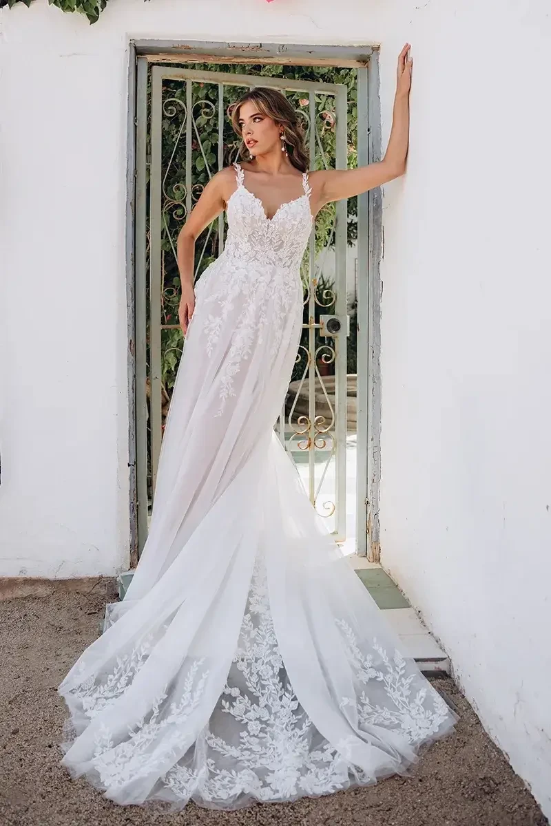 model is wearing an a-line sleeveless lace wedding gown
