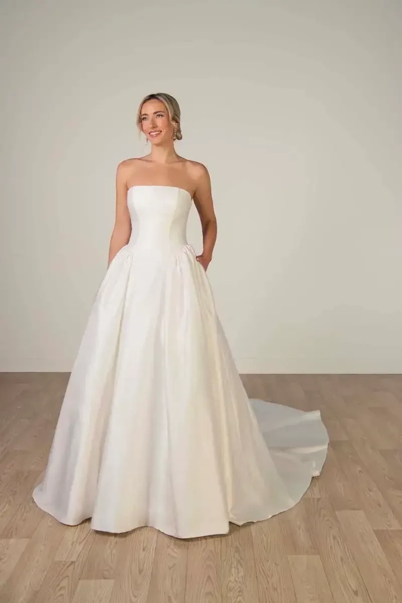 model is wearing a strapless a-line bridal gown